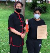 Arav receives his orange belt after passing his grading exam